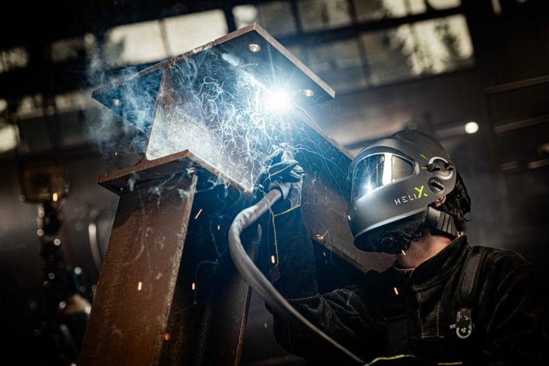 A welder wearing a Helix Helmet doing welding job - image for React Products.